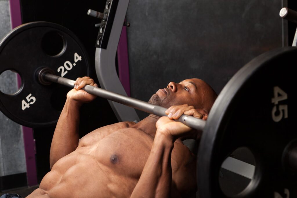 man using weights at the gym