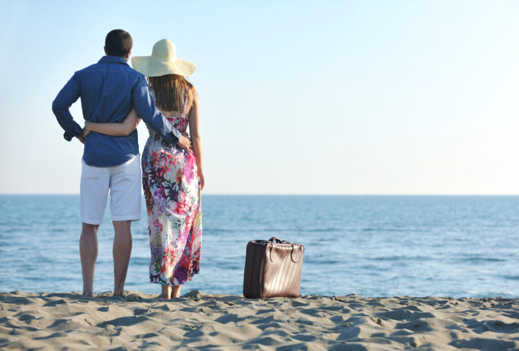 man and woman staring out in the ocean