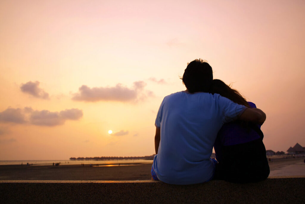 romantic silhouette of couple enjoying sunset